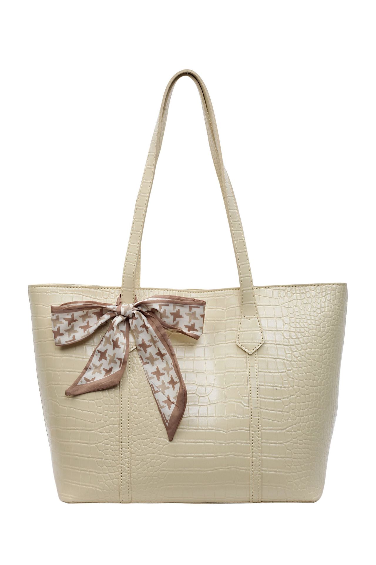 Beige handbag with a decorative bow on a white background