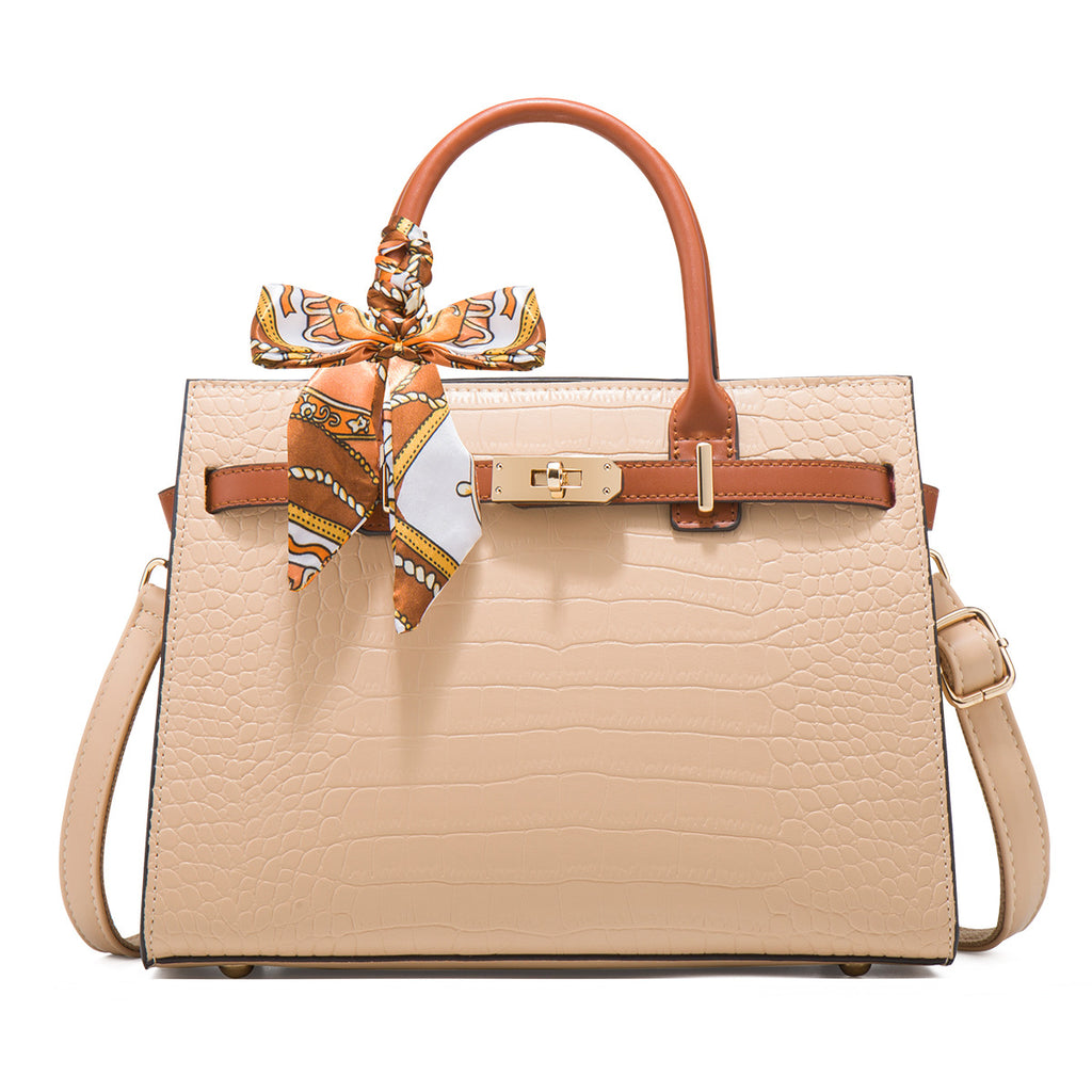 Beige handbag with brown accents and a matching scarf on a white background