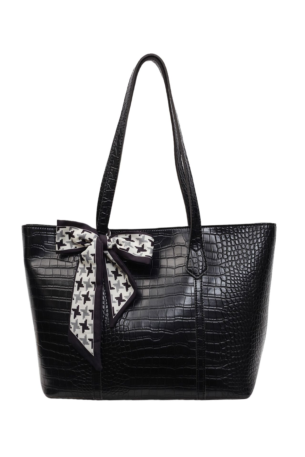 Black crocodile-patterned handbag with a decorative bow on a white background