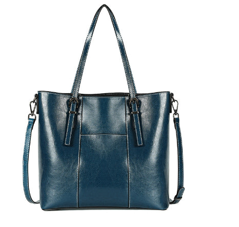 Blue handbag with a shoulder strap on a white background