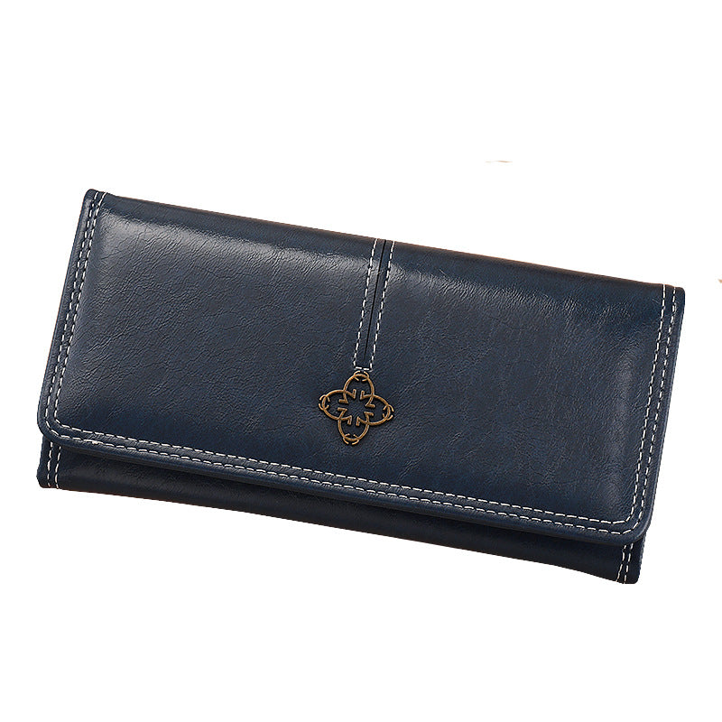 Blue leather wallet with a decorative clasp on a white background
