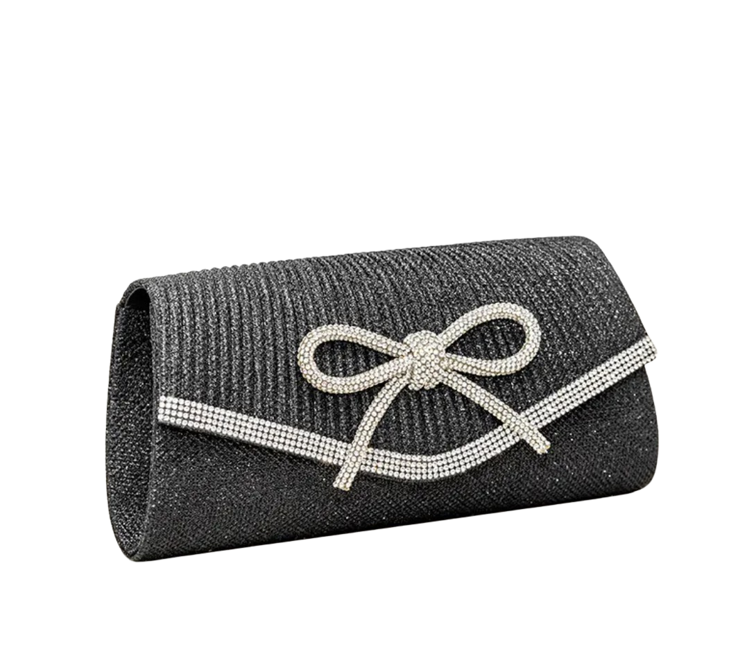 Black clutch bag with a decorative bow on a white background