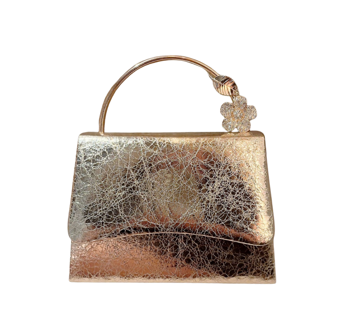 Gold and silver handbag with decorative clasp on a white background