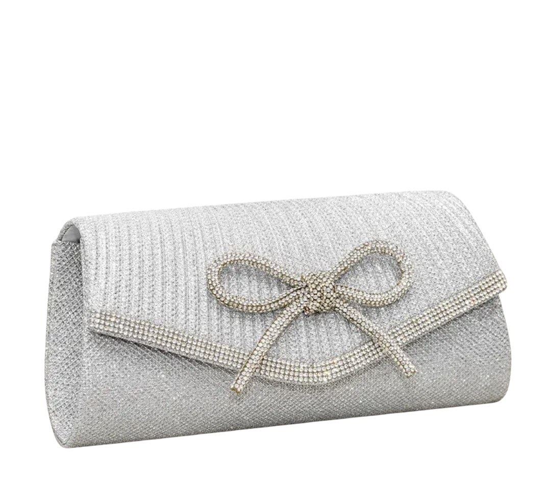 Silver clutch bag with a bow on a white background