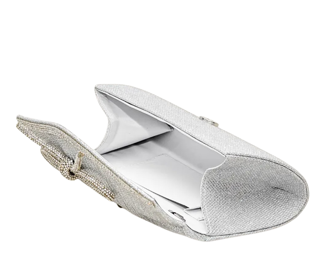 Silver clutch bag with textured surface on a white background opened up to see what can fit