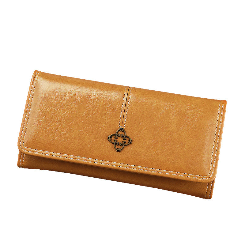 orange leather wallet with a decorative clasp on a white background