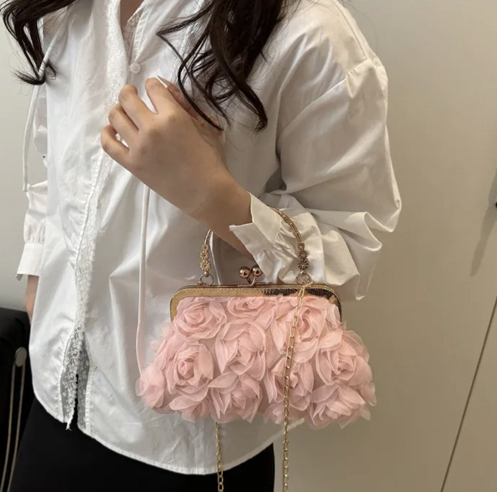 woman holding a pink floral handbag with a plain background