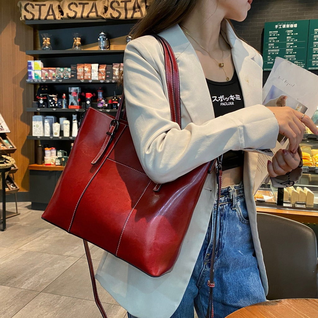 Person holding a red handbag at starbucks before she has to head out