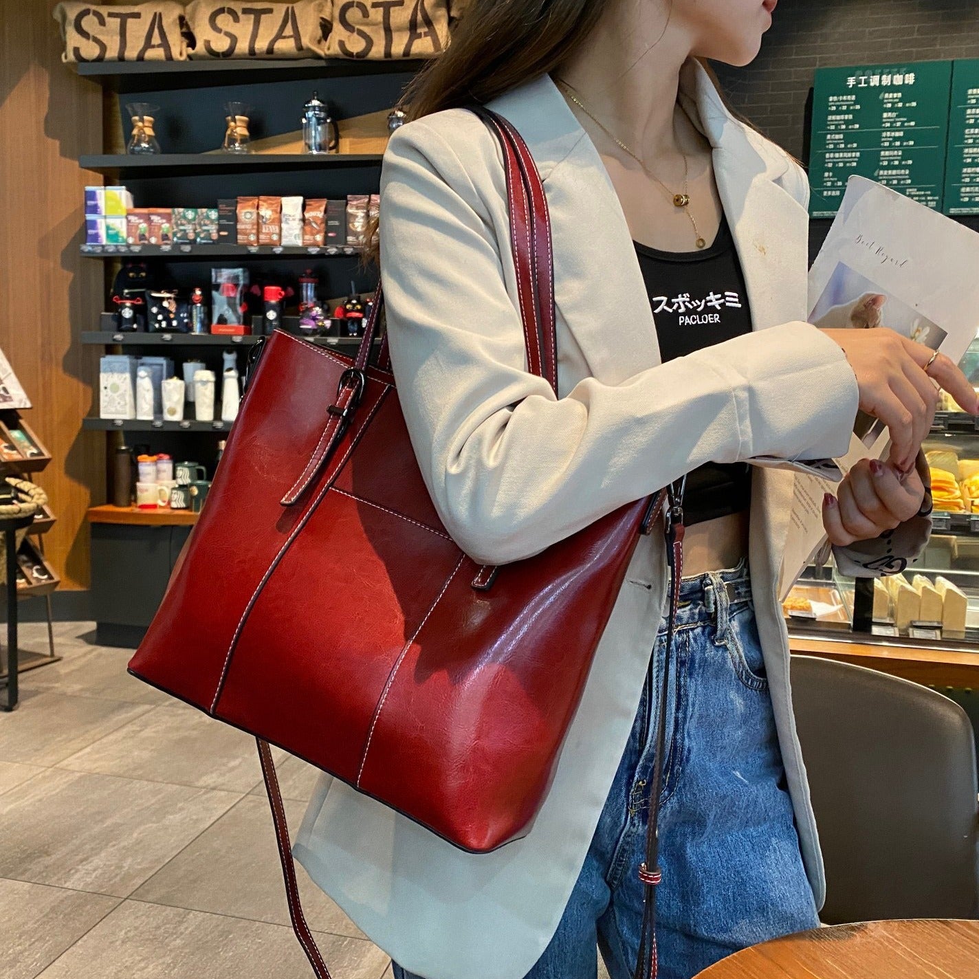 Person holding a red handbag at starbucks before she has to head out
