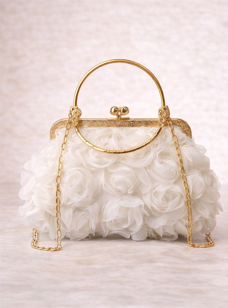 White floral handbag with gold frame and chain on a light background